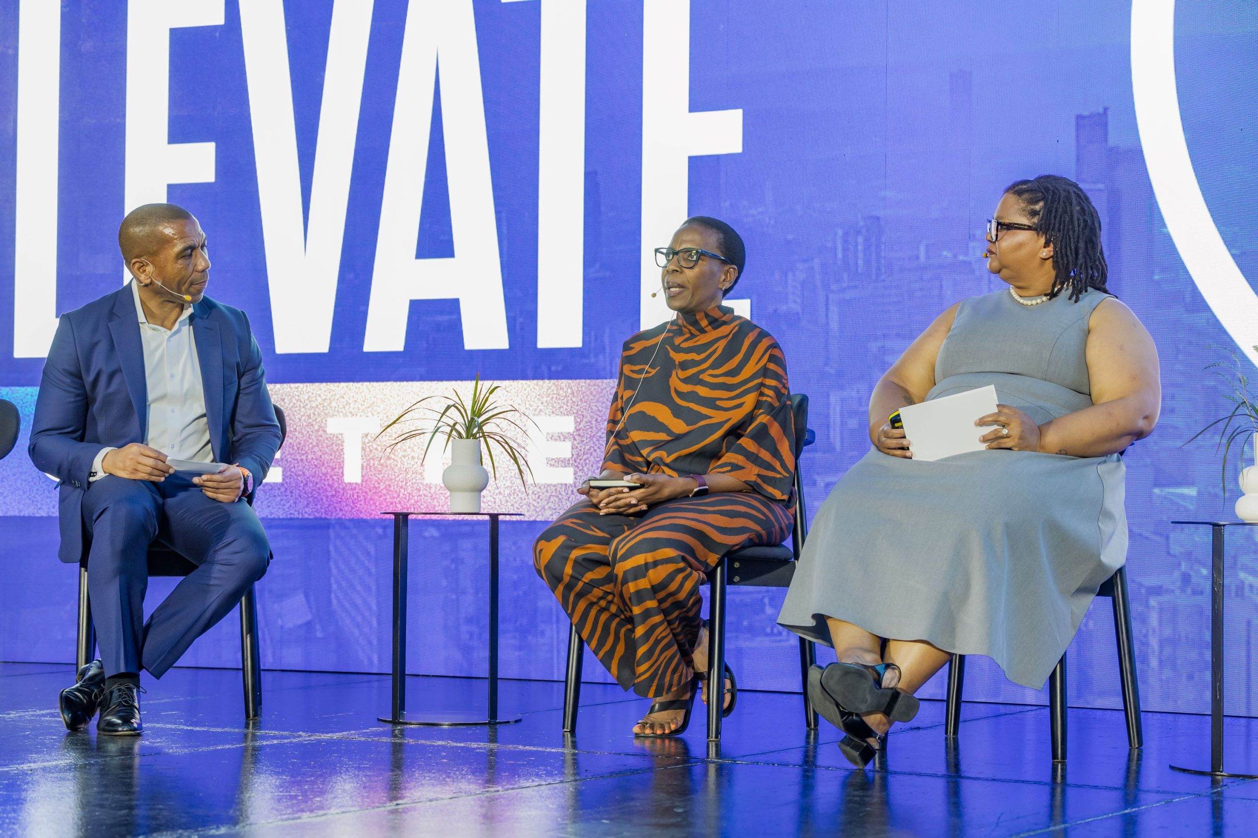 Tsepa Ramoriting (OpenText), Khudu Matlala (Department of Home Affairs) and Noedine Isaacs-Mpulo (Faranani DocTec) in discussion on stage at OpenText Summit Africa 2026.